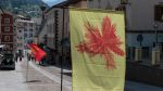 Sergio Rojas Chaves. Flags in the street of Ortisei as part of his Promise of a Living Fossil installation, 2022. Biennale Gherdëina 8.