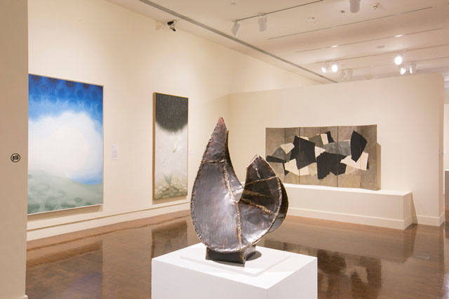 View of Abstract Expressionism: Looking East from the Far West exhibition at Honolulu Museum of Art, Honolulu, Hawaii. Photo by Shuzo Uemoto courtesy of Honolulu Museum of Art. Left to right: Tadashi Sato (American, 1923‒2005). Surf and Water Reflections, 1969‒70. Oil on canvas. Honolulu Museum of Art, Gift of The Contemporary Museum, Honolulu, 2011, and gift of the Honolulu Advertiser Collection at Persis Corporation, 1974. Reproduced by permission of Jan Shimamura. Tadashi Sato (American, 1923‒2005). Falling Leaf, 1966. Oil on linen. Honolulu Museum of Art, Gift of The Contemporary Museum, Honolulu, 2011, and gift of Grant R. Jones, 2003. Reproduced by permission of Jan Shimamura. Bumpei Akaji (American, 1921‒2002). Untitled, 1980. Copper and brass. Honolulu Museum of Art, Gift of The Contemporary Museum, Honolulu, 2011, and gift of the artist, 1981. Reproduced by permission of Esta Akaji Nerney, Ada Akaji and Fiore Fujimoto. Paul Horiuchi (American, 1906‒1999). Abstract Screen, 1961. Paper collage with gouache on six-panel screen. Collection of Nathaniel and Fay Hauberg Page. Artwork by permission of Vincent Horiuchi & Horiuchi Estate.