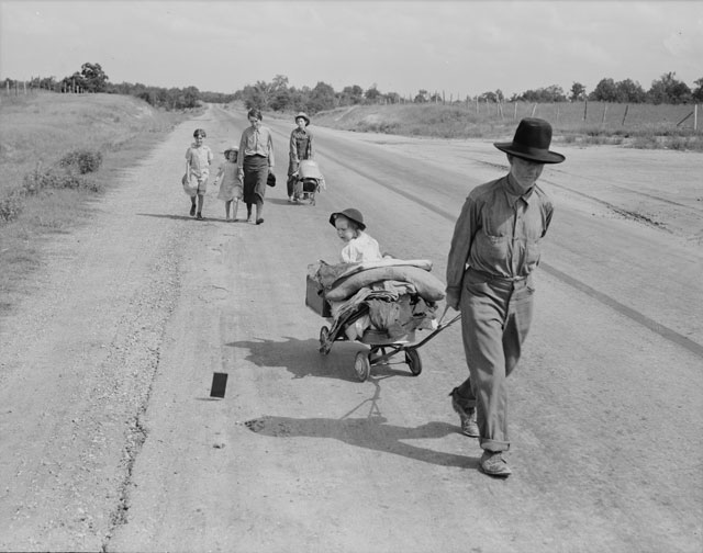 Dorothea Lange. Family walking on highway - five children. Started from Idabel, Oklahoma, bound for Krebs, Oklahoma, June 1938. Library of Congress.