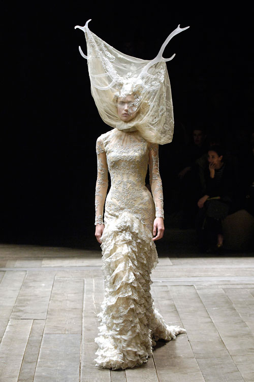 Alexander McQueen. Tulle and lace dress with veil and antlers, Widows of Culloden, A/W 2006–07. Model: Raquel Zimmermann, Viva London, Image: firstVIEW.